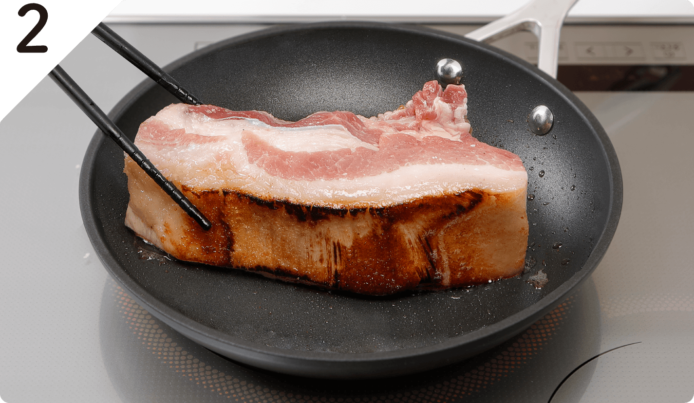 フライパンにオリーブオイル（大さじ1/2分）を強火で熱し、豚肉の表面全体に焼き色をつけて取り出す。